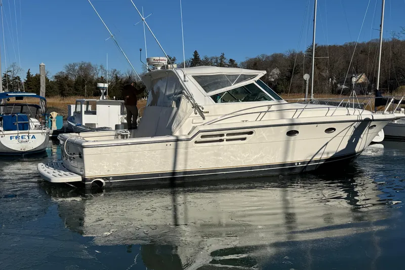Slide: The Image of 1998 Tiara Yachts 4100 Open docked in a marina on a sunny day. - 2