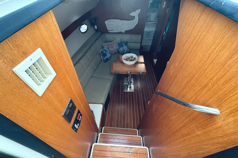 Slide: The Image of Interior of 1998 Tiara Yachts 4100 Open with wooden finish and cozy seating area. - 21