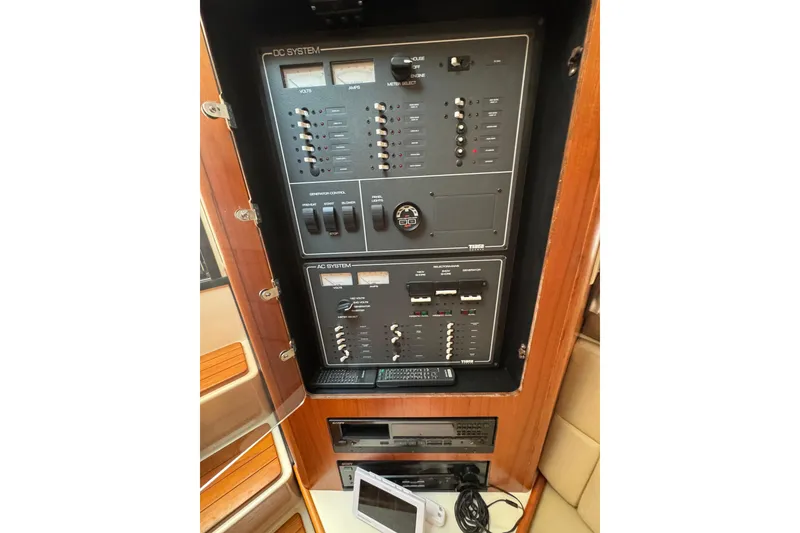 Slide: The Image of Electrical control panel of 1998 Tiara Yachts 4100 Open, featuring DC and AC systems. - 22