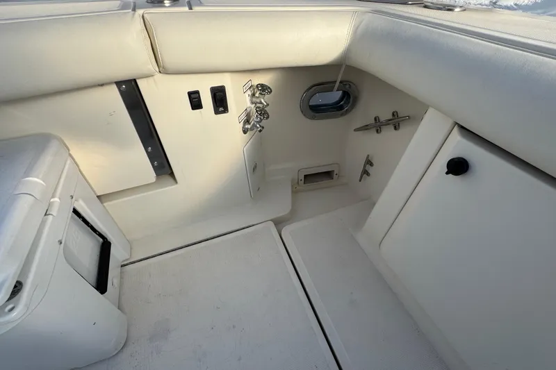 Slide: The Image of 1998 Tiara Yachts 4100 Open interior with white seating and control panel. - 25
