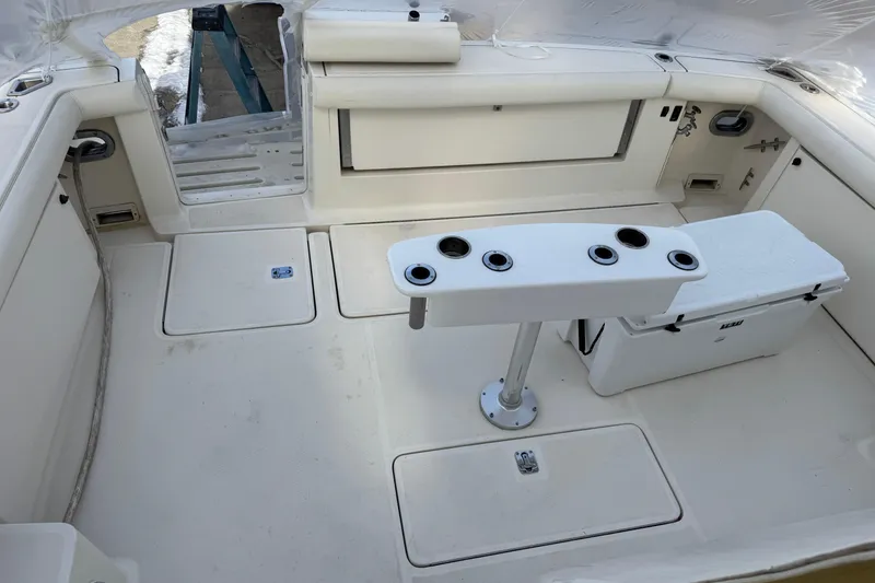Slide: The Image of 1998 Tiara Yachts 4100 Open cockpit with rod holders and storage compartments. - 26
