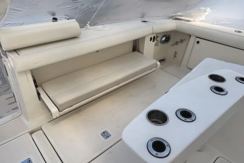 Slide: The Image of 1998 Tiara Yachts 4100 Open interior with white seating and fishing rod holders. - 27