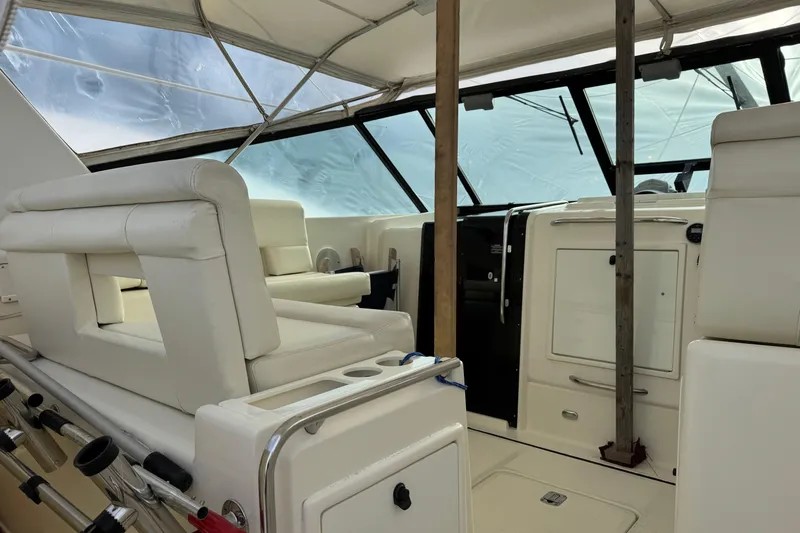Slide: The Image of 1998 Tiara Yachts 4100 Open interior with white seating and helm station. - 29