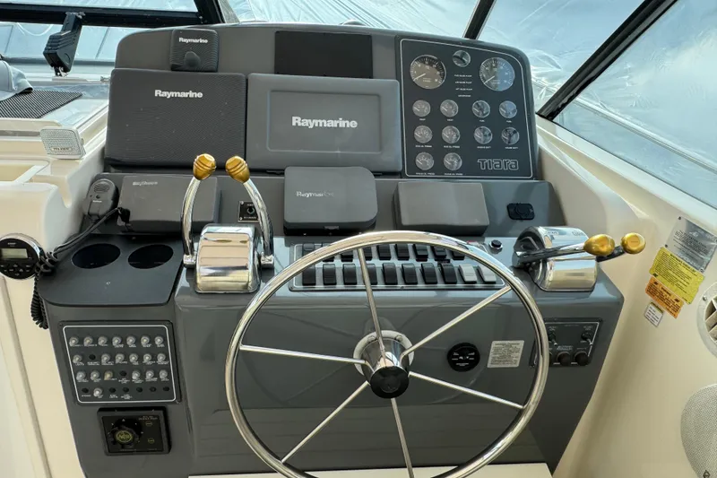 Slide: The Image of 1998 Tiara Yachts 4100 Open helm with Raymarine electronics and dual throttle controls. - 3