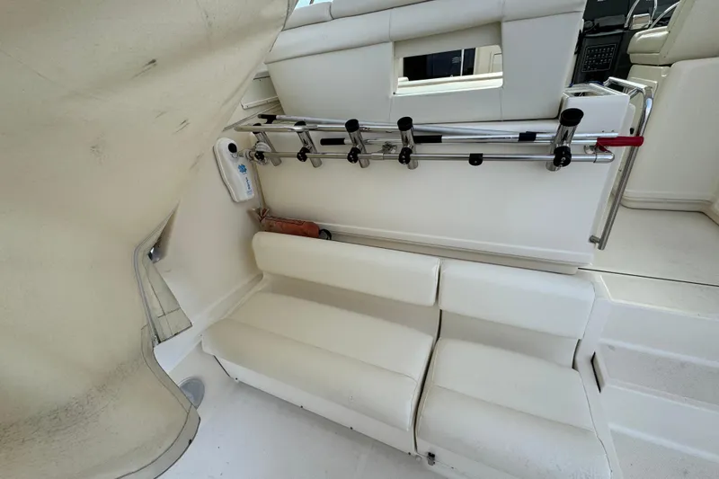 Slide: The Image of 1998 Tiara Yachts 4100 Open interior with white seating and rod holders. - 30
