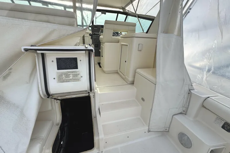 Slide: The Image of 1998 Tiara Yachts 4100 Open interior with helm, seating, and cabin access. - 32