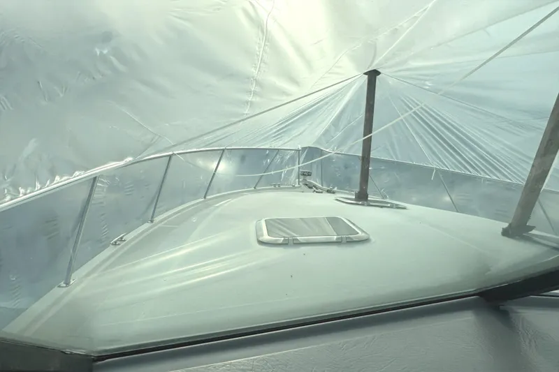 Slide: The Image of 1998 Tiara Yachts 4100 Open under protective cover, showcasing deck and windshield. - 33