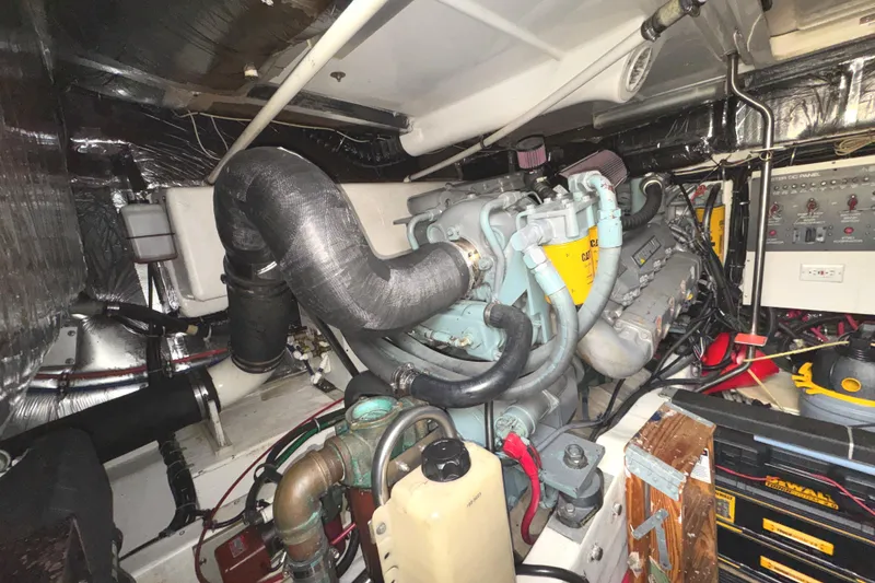 Slide: The Image of Engine room of a 1998 Tiara Yachts 4100 Open, showcasing mechanical components and control panel. - 38