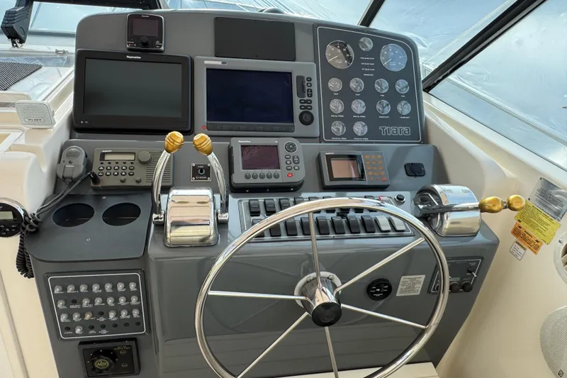 Slide: The Image of 1998 Tiara Yachts 4100 Open helm with navigation instruments and steering wheel. - 4