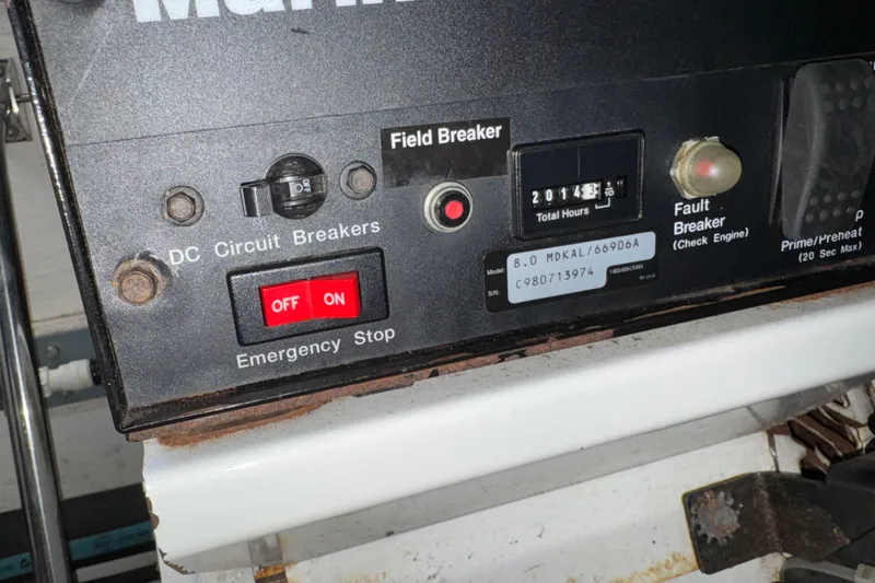 Slide: The Image of Control panel of a 1998 Tiara Yachts 4100 Open, featuring circuit breakers and emergency stop. - 40