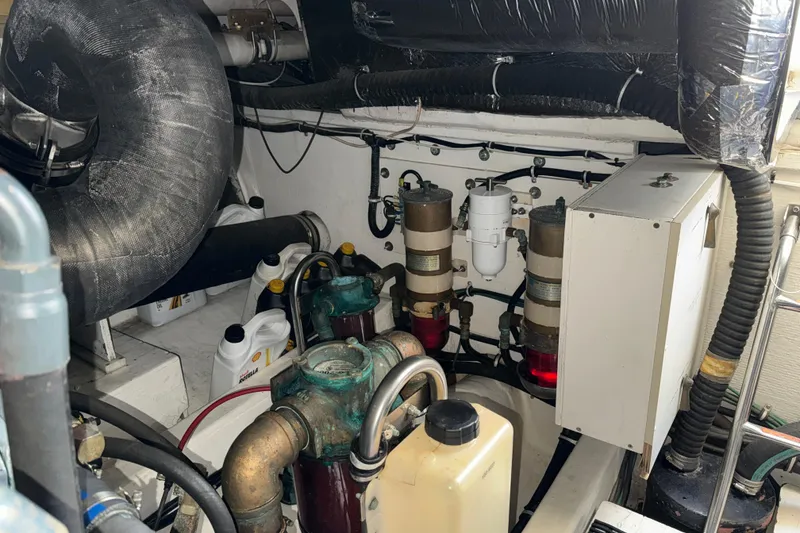 Slide: The Image of Engine room of a 1998 Tiara Yachts 4100 Open, showcasing mechanical components and equipment. - 42