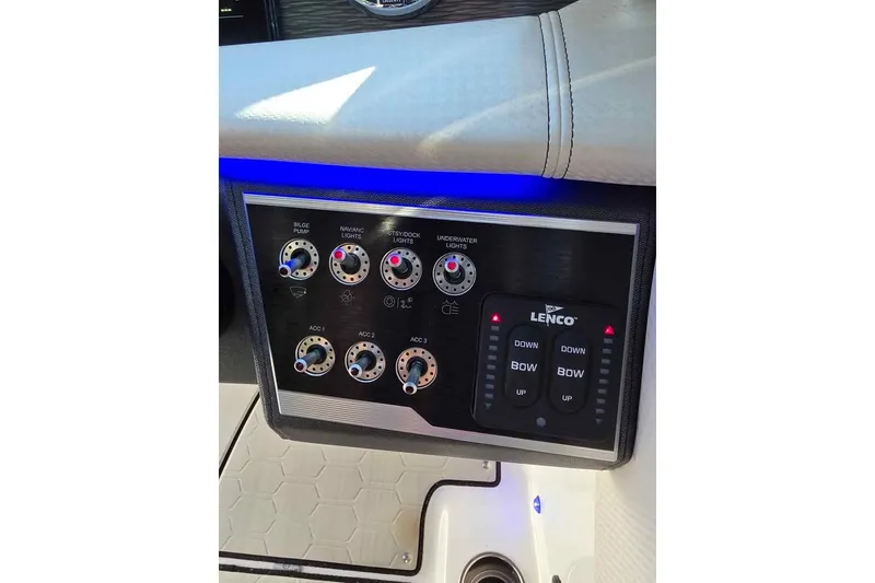 Slide: The Image of 2020 Four Winns HD270 RS boat on trailer, black and red hull, outdoor setting. - 11