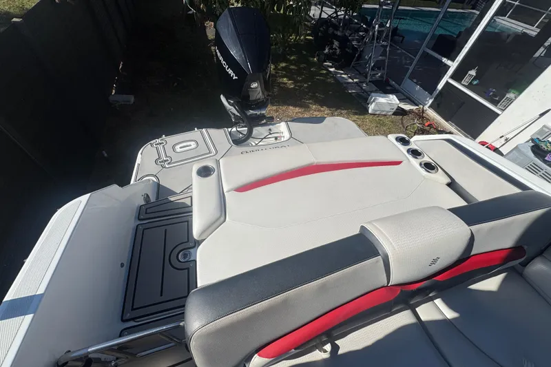 Slide: The Image of 2020 Four Winns HD270 RS boat interior with seating and Mercury outboard motor. - 31