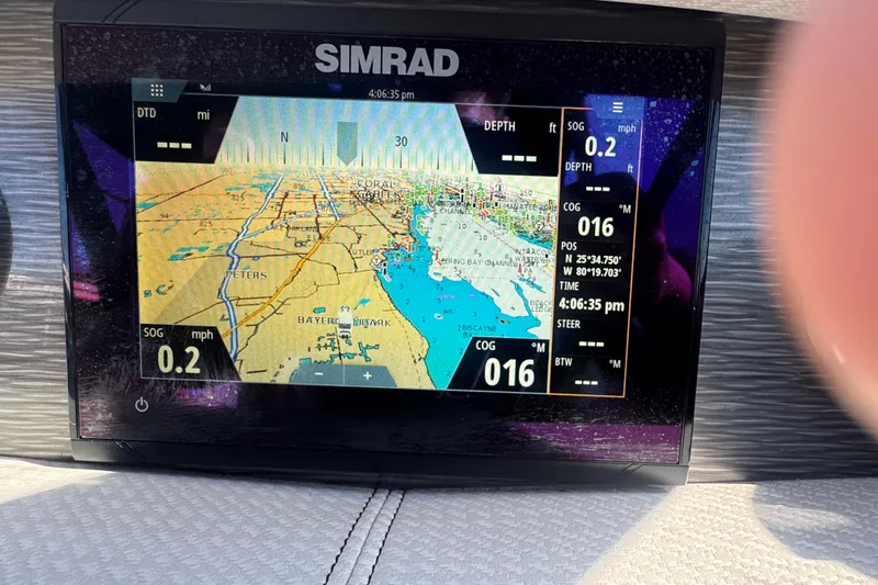 Slide: The Image of Simrad navigation display on 2020 Four Winns HD270 RS boat, showing map and coordinates. - 32