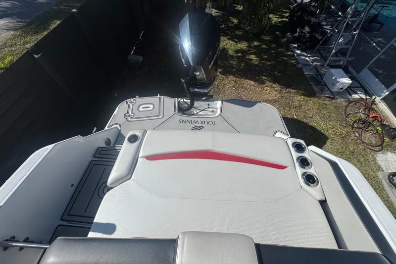 Slide: The Image of 2020 Four Winns HD270 RS boat with sleek seating and outboard motor. - 35