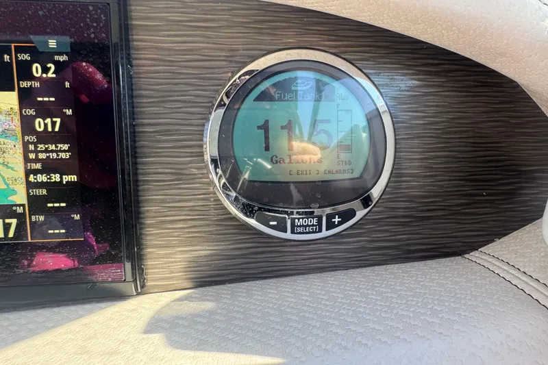 Slide: The Image of Dashboard of 2020 Four Winns HD270 RS showing fuel gauge and navigation display. - 37