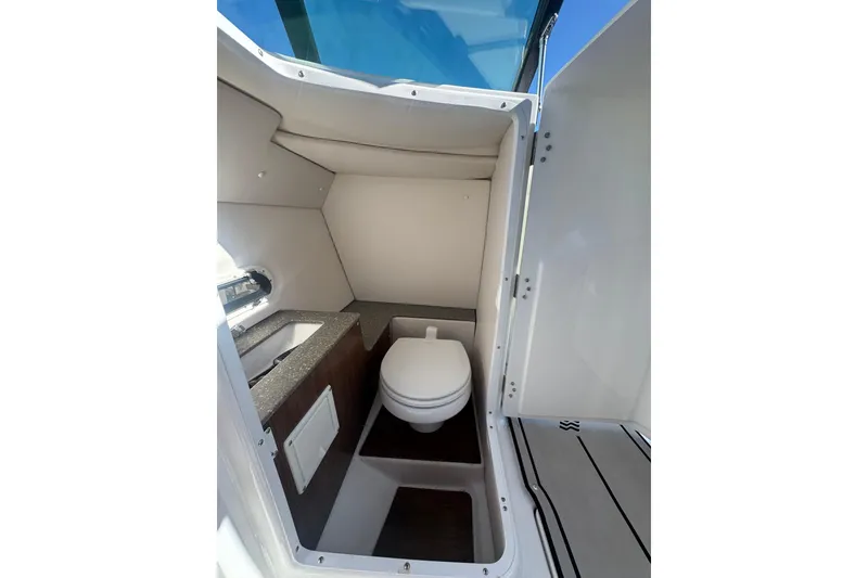 Slide: The Image of 2020 Four Winns HD270 RS boat interior bathroom with toilet and sink. - 40