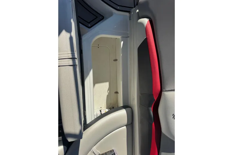 Slide: The Image of 2020 Four Winns HD270 RS boat interior storage compartment with red and gray seating. - 43