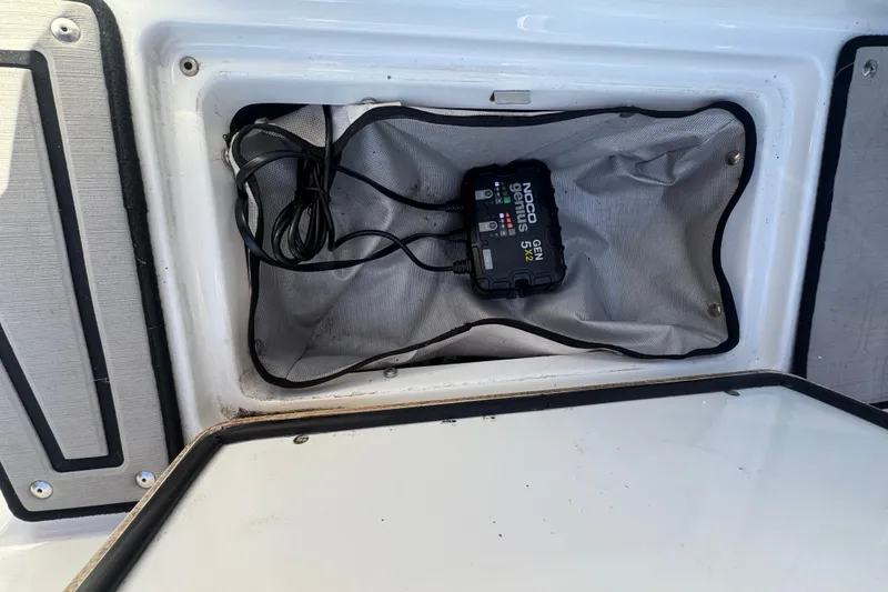 Slide: The Image of 2020 Four Winns HD270 RS boat compartment with NOCO Genius GEN5X2 charger. - 57
