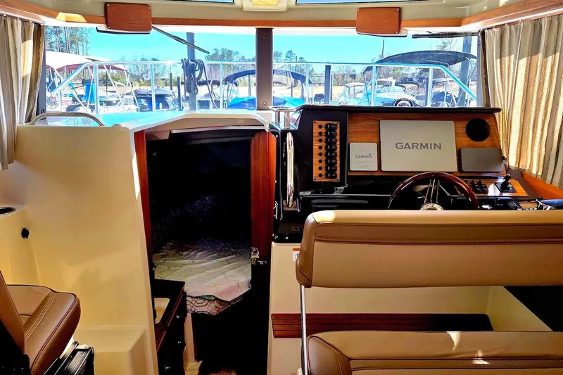 Slide: The Image of Helm of 2022 Ranger Tugs R-27 with Garmin navigation system and wood accents. - 22