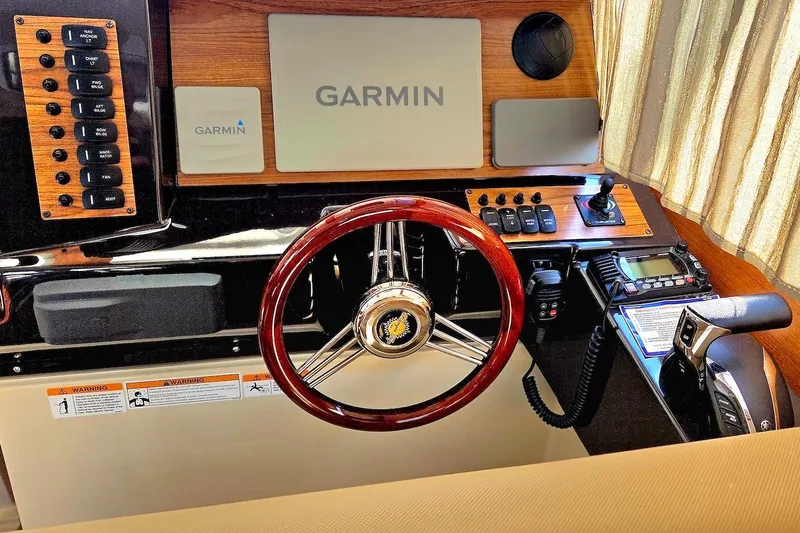 Slide: The Image of 2022 Ranger Tugs R-27 interior with wooden table and beige seating. - 24