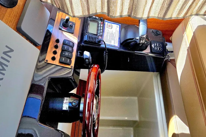 Slide: The Image of 2022 Ranger Tugs R-27 cabin interior with patterned bedding and wooden accents. - 26