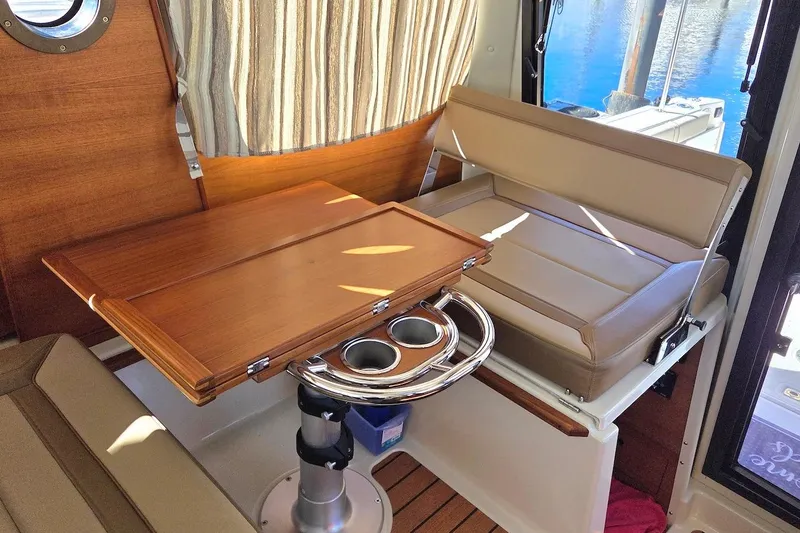 Slide: The Image of 2022 Ranger Tugs R-27 interior cabin with patterned upholstery and cozy sleeping area. - 27