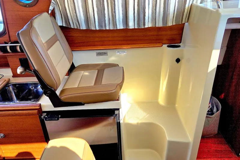 Slide: The Image of Interior of 2022 Ranger Tugs R-27 with wood finish and patterned seating. - 28