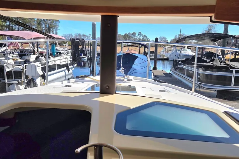 Slide: The Image of 2022 Ranger Tugs R-27 docked at marina, surrounded by other boats. - 30