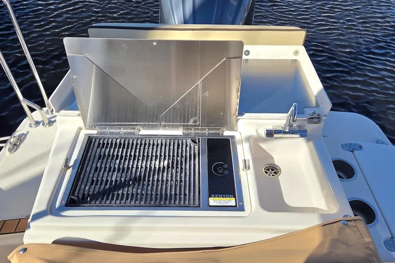 Slide: The Image of Outdoor kitchen on 2022 Ranger Tugs R-27 boat with grill and sink. - 8