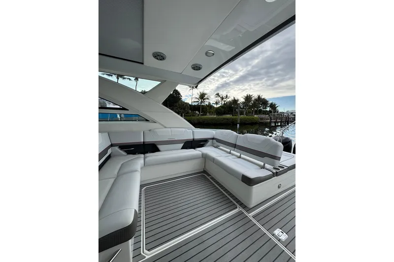 Slide: The Image of 2018 Formula 430 Super Sport Crossover yacht interior with luxurious seating and scenic marina view. - 27