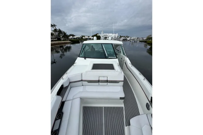 Slide: The Image of 2018 Formula 430 Super Sport Crossover boat on calm water, featuring spacious seating. - 28