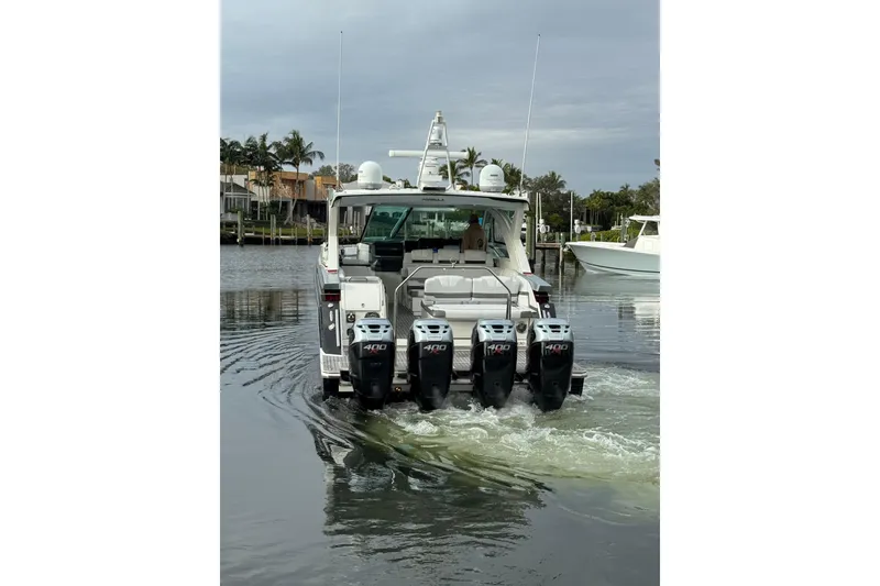 Slide: The Image of 2018 Formula 430 Super Sport Crossover boat with four outboard engines on water. - 4