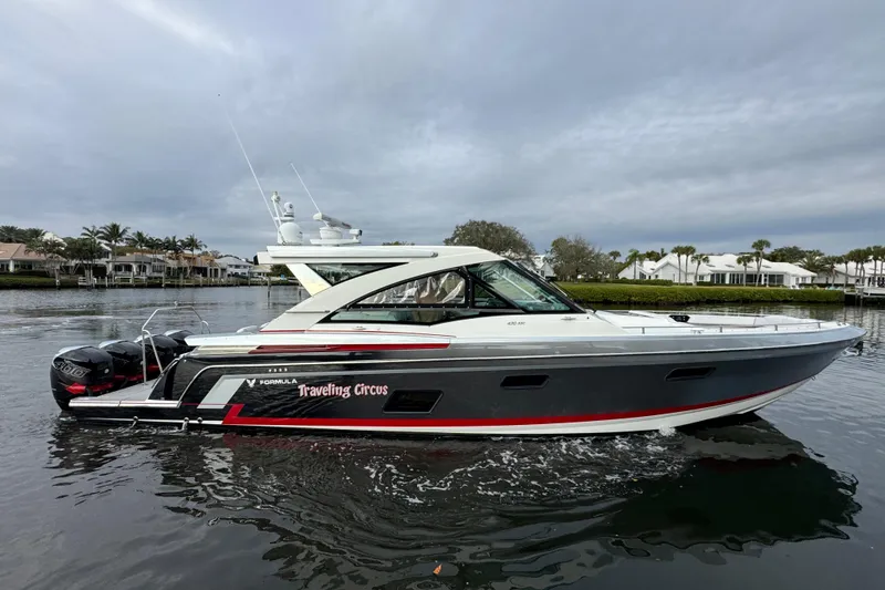 Slide: The Image of 2018 Formula 430 Super Sport Crossover boat on calm water, overcast sky. - 6