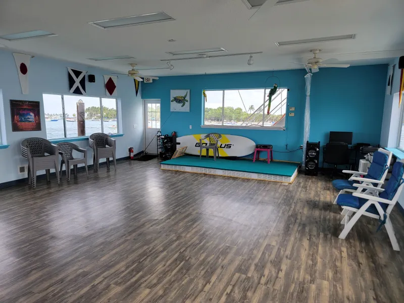 Slide: The Image of Spacious floating home interior with wooden floors, nautical decor, and large windows overlooking water. - 17