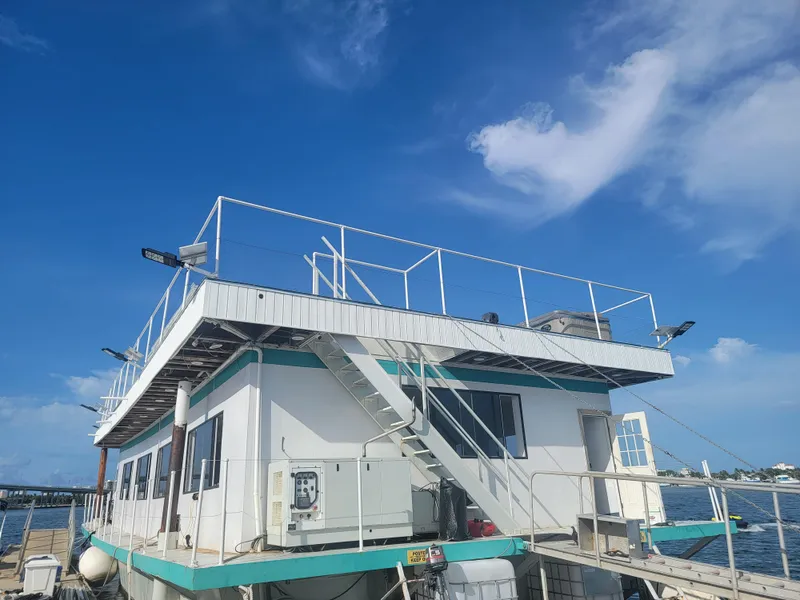 Slide: The Image of Custom 2003 floating home with rooftop deck against a clear blue sky. - 27