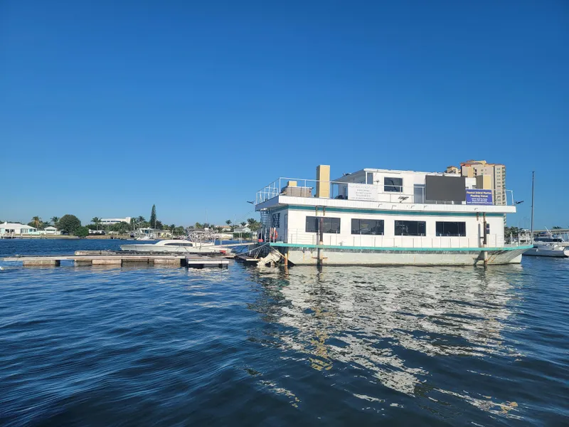 Slide: The Image of Custom 2003 floating home on water, clear blue sky, docked near marina. - 32