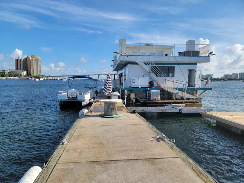 Slide: The Image of Custom 2003 floating home docked on a sunny waterfront with boats and city skyline. - 40