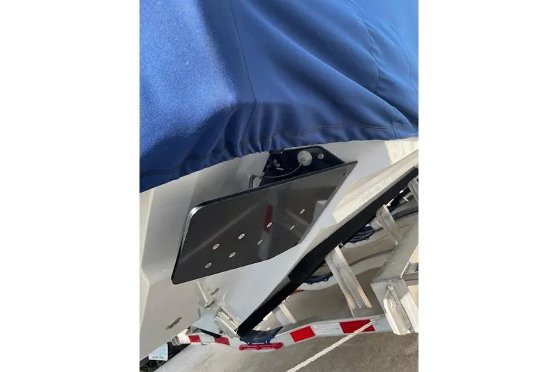 Slide: The Image of 2024 Contender 32 ST boat with blue cover and trim tab detail. - 14