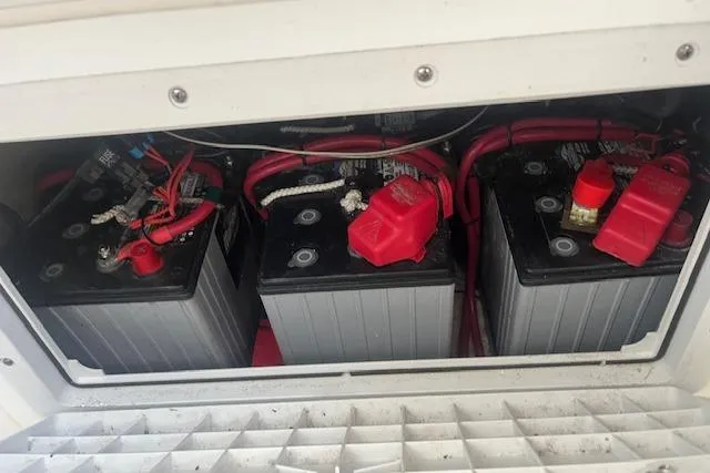 Slide: The Image of Batteries in a 2024 Contender 32 ST boat, connected with red cables. - 18
