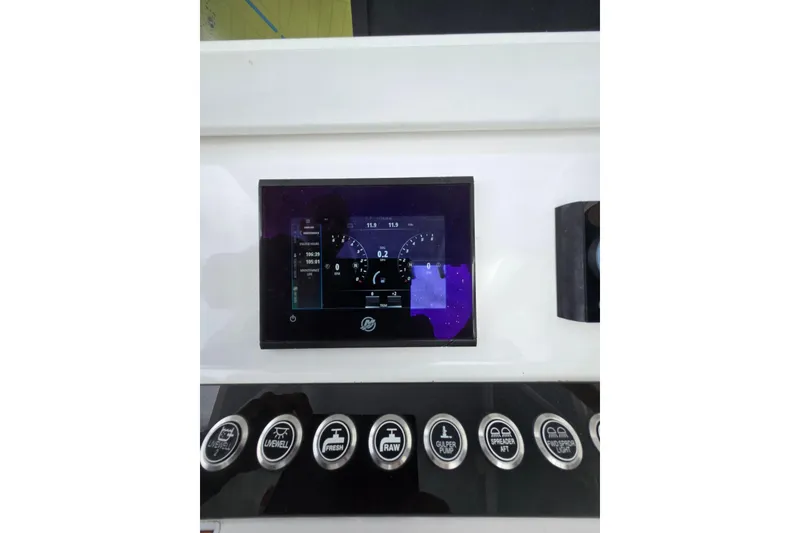 Slide: The Image of 2024 Contender 32 ST dashboard with digital display and control buttons. - 21