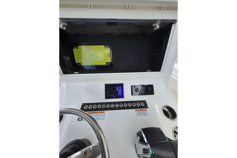 Slide: The Image of 2024 Contender 32 ST boat dashboard with navigation and control systems. - 22
