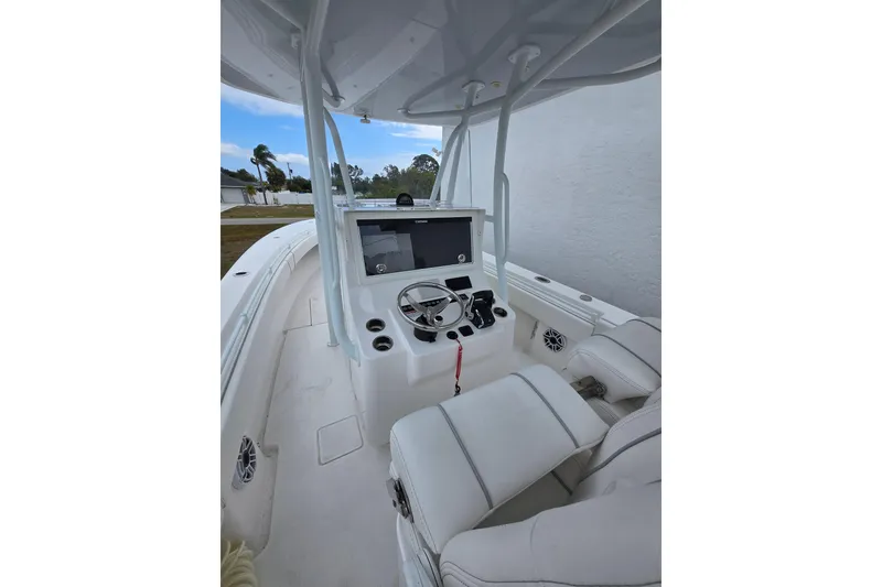 Slide: The Image of 2024 Contender 32 ST boat cockpit with steering wheel and navigation system. - 23