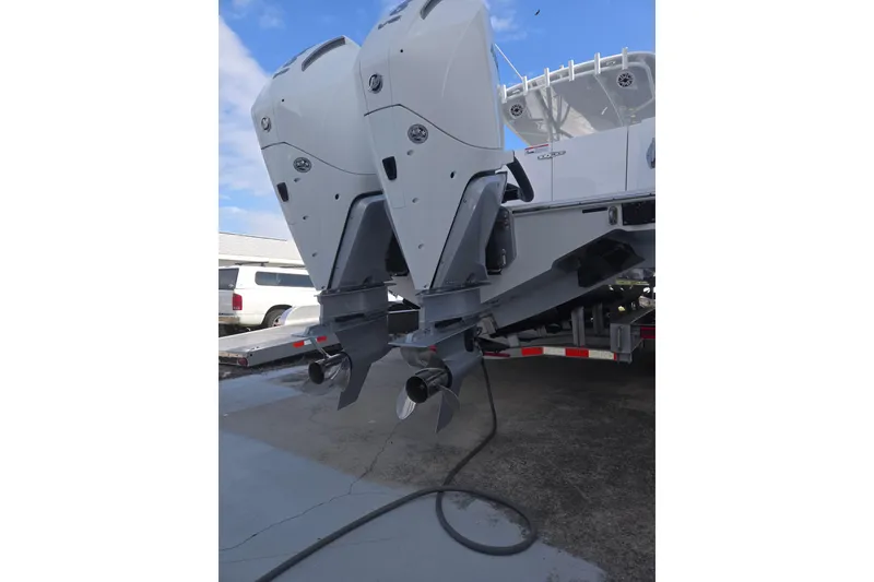 Slide: The Image of 2024 Contender 32 ST boat with dual outboard motors on a trailer. - 26