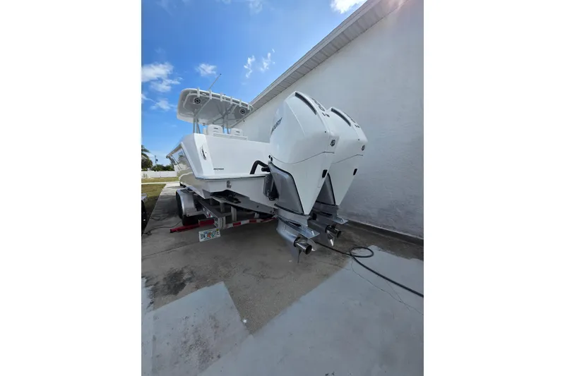 Slide: The Image of 2024 Contender 32 ST boat with dual outboard engines on a trailer. - 28