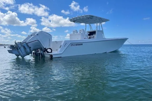 Slide: The Image of 2024 Contender 32 ST boat on calm ocean under blue sky. - 3