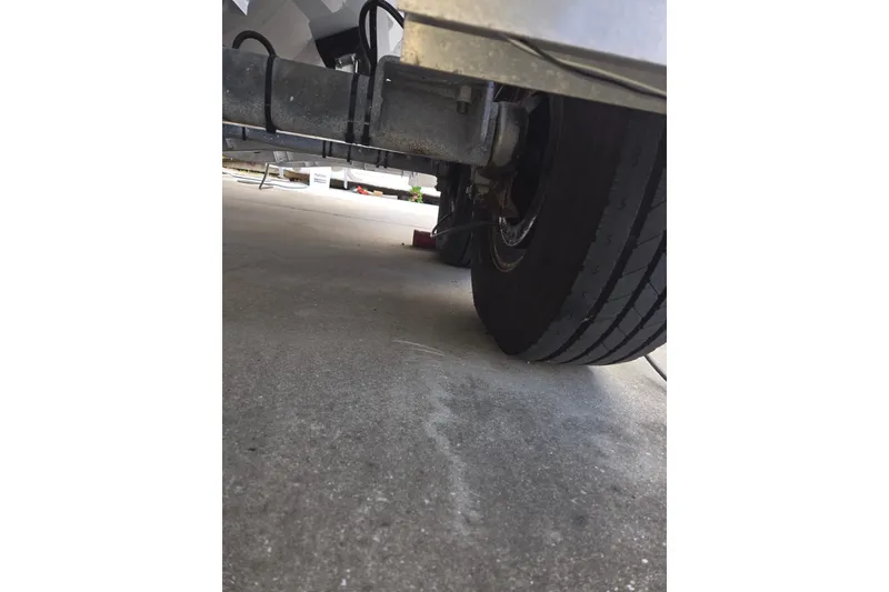 Slide: The Image of Underneath view of a 2024 Contender 32 ST trailer tire on concrete. - 31