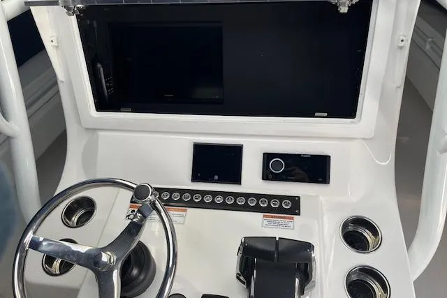 Slide: The Image of 2024 Contender 32 ST boat dashboard with steering wheel and control panel. - 5