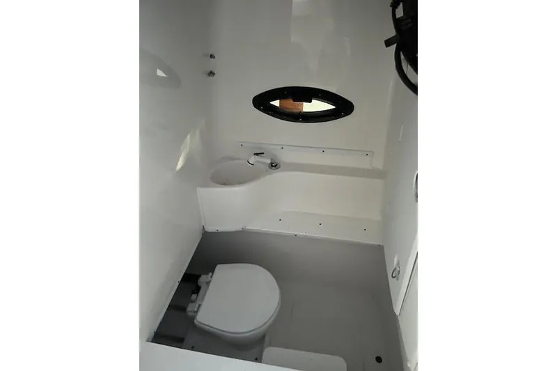 Slide: The Image of 2024 Contender 32 ST boat interior bathroom with toilet and sink. - 6