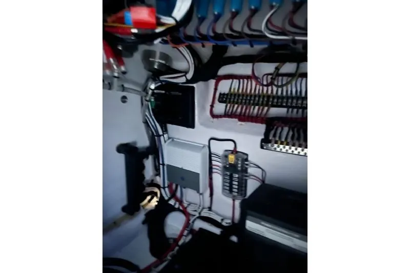 Slide: The Image of Electrical wiring inside 2024 Contender 32 ST boat, showcasing complex connections and components. - 7